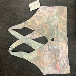 Sports bra with a twist design, fun pattern, and pastel colors